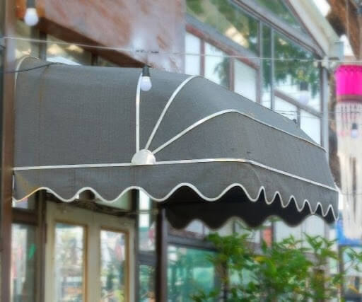 Scalloped black canopy over a business entrance