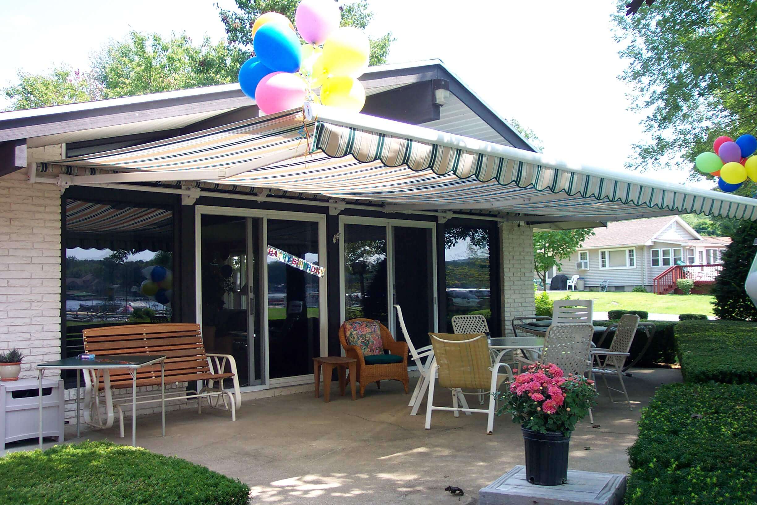 Folding lateral arm retractable canopy over a cozy porch